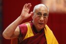 Tibet's exiled spiritual leader the Dalai Lama waves to the audience after his first speech during the European Tibetan Buddhist Conference in Fribourg