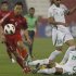 FILE - In Jan. 19, 2011 file photo, North Korea's player Jong Tae Se, left, fights for the ball with Iraq's player Ahmed Ibrahim during their AFC Asian Cup group D soccer match at Al-Rayyan Stadium, in Doha, Qatar.  South Korean club, The Suwon Samsung Bluewings said Thursday, Jan. 3, 2013 it has acquired North Korea striker Jong from Germany's Cologne. (AP Photo/Kin Cheung, File)