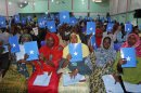 In this photo of Wednesday July 25, 2012, Somalia's constituency assembly members hold up copies of the proposed new constitution during the beginning of a nine-day meeting on Wednesday to examine, debate and vote on the proposed new constitution, in Mogadishu, Somalia. Somali leaders are debating a new constitution that protects the right to abortion to save the life of the mother and bans the circumcision of girls. (AP Photo/Farah Abdi Warsameh)