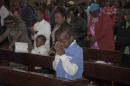 A Kenyan Christian child in prayer as he joins a morning service at Holy Family Basilica, Nairobi, Kenya, Sunday, April 5, 2015, during Easter Sunday when Christians celebrate the resurrection of their Lord, Jesus Christ, according to Scripture after his crucifixion on the cross. Special prayers were held Sunday for the victims of the recent Garissa University Attack, when Al-Shabab gunmen rampaged through the university in northeastern Kenya on Thursday, killing scores of people. (AP Photo/Sayyid Azim)