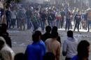 Egyptian supporters of the Muslim Brotherhood clash with supporters of the military in the southern Cairo Giza district on January 24, 2014
