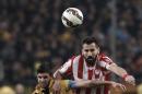 Greek league leader Olympiakos' Dimitris Siovas. right, fights for the ball with second division AEK's Helder Barbosa during a Greek Cup quarter final, second leg soccer match, at the Olympic stadium, in Athens, on Wednesday, March 11, 2015. The two teams drew 1-1 in the first leg game. (AP Photo/Petros Giannakouris)
