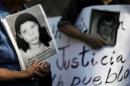 Relatives of war victims protest against Carlos Eugenio Vides Casanova, former Salvadorean minister of defense from 1983-1989, upon his arrival at El Salvador International Airport
