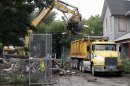 Debris is loaded onto a truck at a house where three women were held captive and raped for more than a decade, Wednesday, Aug. 7, 2013, in Cleveland. Authorities want to make sure the rubble isn't sold online as "murderabilia," though no one died there. The house was torn down as part of a deal that spared Ariel Castro a possible death sentence. He was sentenced last week to life in prison plus 1,000 years. He apologized but blamed his addiction to pornography. (AP Photo/Tony Dejak)