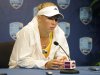 Caroline Wozniacki, of Denmark, speaks with reporters after retiring from her semifinal match, after losing the first set 7-5, against Maria Kirilenko, of Russia, at the New Haven Open tennis tournament in New Haven, Conn., on Friday, Aug. 24, 2012. A right knee injury suffered in the quarterfinals forced the retirement. (AP Photo/Fred Beckham)