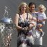 FILE - In this May 30, 2011 file photo, IndyCar driver Dan Wheldon, of England, poses with his family, wife Susie, left, holding Oliver, and Sebastian, right, next to the Borg-Warner Trophy during the traditional winners photo of the Indianapolis 500 auto race champion on the start/finish line at the Indianapolis Motor Speedway in Indianapolis. Seven months after the accident that killed her husband, Wheldon heads to the Indianapolis 500, for ceremonies honoring the defending race winner. She'll arrive Thursday night and spend the weekend, accompanied by her two sons, who were present for their dad's surprise win last year, but isn't sure if she'll attend Sunday's race.   (AP Photo/Michael Conroy, File)