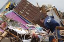 A resident who did not want to give his name, searches through the rubble of his mobile home in the Steelman Estates Mobile Home Park, destroyed by Sunday's tornado, near Shawnee, Okla., Monday, May 20, 2013. The tornado that slammed into Oklahoma on Sunday is now blamed for two deaths. Authorities say two men in their 70s have been found dead in or near a mobile home park outside of Shawnee. (AP Photo Sue Ogrocki)