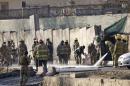 Afghan fire-fighters and members of security forces clean the site of a suicide attack in Kabul, Afghanistan