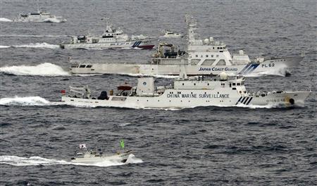 An aerial photo shows a Chinese marine surveillance ship Haijian No. 66 (C) cruising next to Japan Coast Guard patrol ships in the East China Sea, near known as Senkaku isles in Japan and Diaoyu islands in China, in this photo taken by Kyodo April 23, 2013. REUTERS/Kyodo