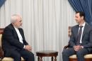 Syrian President Bashar al-Assad (R) meeting with Iranian Foreign Minister Mohammad Javad Zarif in Damascus on August 12, 2015
