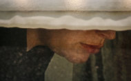 A detail section from the Photography of Arne Svenson as it hangs inside the Julie Saul Gallery on Thursday, May 16, 2013 in New York. Residents of a New York luxury apartment building are livid over an exhibition of photos secretly snapped through their apartment windows. (AP Photo/Bebeto Matthews)