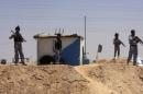 Members of the Iraqi security forces patrol an area near the borders between Karbala Province and Anbar Province
