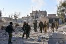 Syrian pro-government forces inspect an area in the Masaken Hanano district in eastern Aleppo November 27, 2016, a day after they resized it from rebel fighters