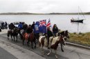 Falkland islanders ride their horses during a parade in Stanley