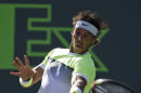 Rafael Nadal, of Spain, hits a return to Fernando Verdasco at the Miami Open tennis tournament, Sunday, March 29, 2015, in Key Biscayne, Fla. (AP Photo/Lynne Sladky)