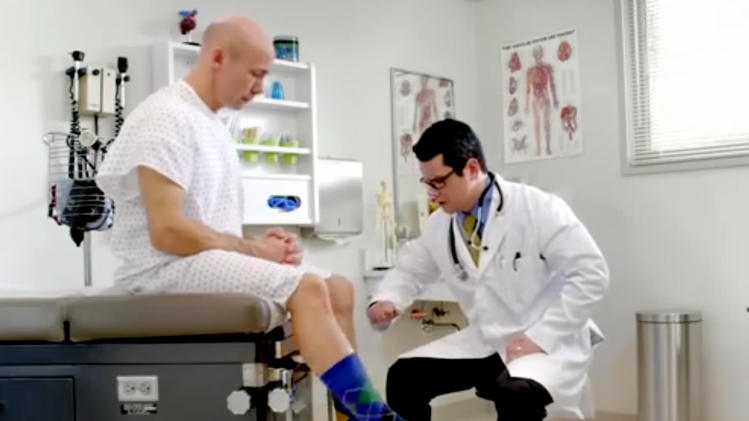 In this image from video provided by Wellmark Blue Cross and Blue Shield, a man kicks the wrong leg as a doctor checks his reflexes in an ad from the Midwestern insurer. Wellmark launched ads recently in Iowa and South Dakota poking fun at technical problems that have plagued the federal government’s insurance enrollment website while trying to lure away some potential customers. (AP Photo/Wellmark Blue Cross and Blue Shield)