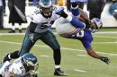 New York Giants' Wilson is tackled by Philadelphia Eagles' Asomugha and Chaney in their NFL football game in East Rutherford