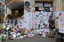 People visit a makeshift memorial near the headquarters of the French satirical weekly Charlie Hebdo on January 12, 2015 in Paris