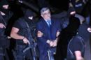 The leader of Greece's Golden Dawn party Nikos Michaloliakos (centre) is escorted by police to a courthouse in Athens, on October 2, 2013