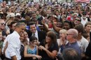 U.S. President Obama poses with crowd members at a campaign event in Florida