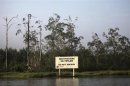 A warning sign belonging to the company Royal Dutch Shell is seen along the Nembe creek in Nigeria's oil state of Bayelsa