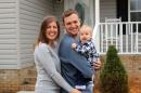 This Dec. 7, 2013 photo released by The Williamson family shows, from left, Tricia Williamson, her husband Mike Williamson, and their one-year-old son Adam at their home in Liberty, N.C. Tricia Williamson, 30, in Liberty, N.C., quit her job as an editor and producer at a TV station after crunching the numbers and realizing her salary after the birth of her son a year ago would go primarily to her commuting and child care expenses. (AP Photo/Rick Williamson)
