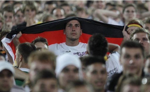 Fans react during the public screening of the Euro 2012 semi-final soccer match between Germany and Italy in Frankfurt