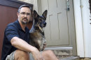 In this Monday, July 23, 2012 photo, retired U.S. Marine Todd Kennedy poses on his front stoop with his pet, Malcolm, in San Diego. Kennedy served two tours in Iraq. He no longer follows the news there, focusing instead on studying history and anthropology at San Diego State University. 