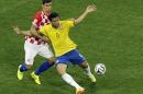 Brazil's Fred, right, falls after making contact with Croatia's Dejan Lovren during the group A World Cup soccer match between Brazil and Croatia, the opening game of the tournament, in the Itaquerao Stadium in Sao Paulo, Brazil, Thursday, June 12, 2014. (AP Photo/Thanassis Stavrakis)