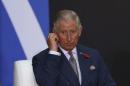 Britain's Prince Charles adjusts his earpiece during a signing ceremony for cooperation agreements between United Kingdom and Mexico at National Palace in Mexico City
