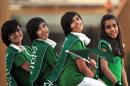 Saudi girls wear the national flag across their shoulders during celebrations on Saudi Arabian National Day in Riyadh, on September 23, 2013