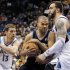 San Antonio Spurs guard Tony Parker, center, of France, drives around Minnesota Timberwolves center Nikola Pekovic, of Montenegro, right, and guard Luke Ridnour (13) during the first half of an NBA basketball game Wednesday, Feb. 6, 2013, in Minneapolis. (AP Photo/Genevieve Ross)