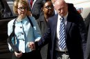 Former Democratic Rep. Gabrielle Giffords, left, and her husband Mark Kelly leave after the sentencing of Jared Loughner, in back of U.S. District Court Thursday, Nov. 8, 2012, in Tucson, Ariz. U.S. District Judge Larry Burns sentenced Jared Lee Loughner, 24, to life in prison, for the January 2011 attack that left six people dead and Giffords and others wounded. Loughner pleaded guilty to federal charges under an agreement that guarantees he will spend the rest of his life in prison without the possibility of parole. (AP Photo/Ross D. Franklin)