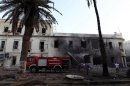 Libyan firefighters battle a fire caused by a blast near a foreign ministry building on September 11, 2013 in Benghazi