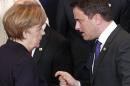 German Chancellor Angela Merkel, left, speaks with Luxembourg's Prime Minister Xavier Bettel during a group photo at an EU summit in Brussels on Thursday, March 20, 2014. The EU Commission president wants a two-day summit of European Union leaders to center on boosting the fledgling government in Kiev rather than focus exclusively on sanctions against Russia over its annexation of Ukraine's Crimea peninsula. (AP Photo/Yves Logghe)