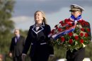 U.S. Secretary of State Hillary Rodham Clinton and U.S. Navy Vice Adm. Harry B. Harris Jr. pay their respects during a ceremony at the Monument to the Heroic Defenders of Leningrad, in St. Petersburg