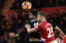 Chelsea's striker Diego Costa (L) vies in the air with Middlesbrough's defender Calum Chambers during the English Premier League football match November 20, 2016