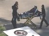 Frame grab of police and emergency personnel evacuating an injured male on a stretcher outside a building on the Lone Star College Campus near Houston