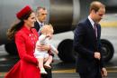 Prince William, his wife Kate and baby Prince George arrive at the international airport in Wellington on April 7, 2014