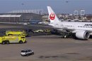 Fire trucks surround Japan Airlines Boeing 787 Dreamliner that caught fire at Logan International Airport in Boston