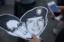 A member of German Piraten Partei (Pirates party) holds the portraits of U.S. Army Private First Class Manning and Snowden, a former contractor at the National Security Agency (NSA), during a protest in Berlin's Tiergarten district