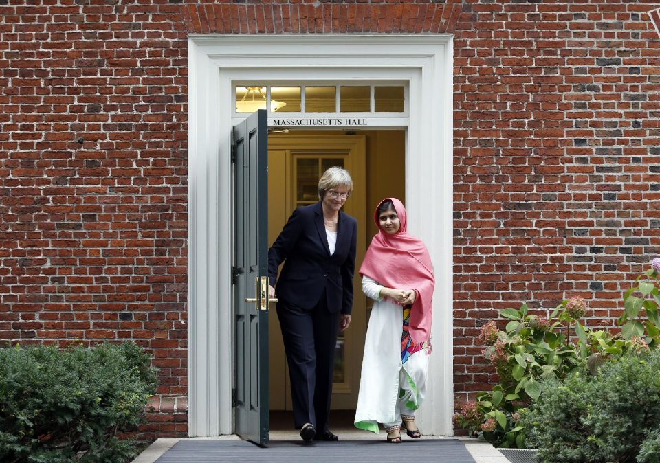 Malala Yousafzai, right, leaves Massachusetts Hall with Harvard President Drew Gilpin Faust to a news conference on the school's campus in Cambridge, Mass. on Friday, Sept. 27, 2013. The Pakistani teenager, an advocate for education for girls, survived a Taliban assassination attempt last year on her way home from school. (AP Photo/Jessica Rinaldi)
