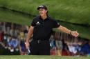 Phil Mickelson reacts after hitting onto the 16th green during the fourth round of the Masters golf tournament Sunday, April 12, 2015, in Augusta, Ga. (AP Photo/Matt Slocum)