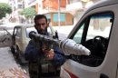A Syrian rebel fighter holds a rocket propelled grenade (RPG) in the Salaheddin district of Aleppo