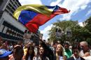 The wife of jailed opposition leader Leopoldo Lopez, Lilian Tintori (C), waves a national flag in Caracas on September 4, 2015