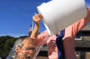 In this image from video posted on Facebook, courtesy of the George W. Bush Presidential Center, former President George W. Bush participates in the ice bucket challenge with the help of his wife, Laura Bush, in Kennebunkport, Maine. The challenge has caught on with notable figures participating in the campaign to raise money for the fight against ALS, or Lou Gehrig's disease. The phenomenal success of the fundraising craze is making charitable organizations rethink how they connect with a younger generation of potential donors, specifically through social media. (AP Photo/Courtesy George W. Bush Presidential Center)