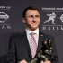 Heisman Trophy finalist Johnny Manziel of Texas A&M, poses with the Heisman Trophy following a news conference prior to the announcement of the winner, Saturday, Dec. 8, 2012 in New York. (AP Photo/Henny Ray Abrams)