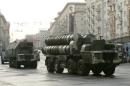 Russian military vehicles move along a central street during a rehearsal for a military parade in Moscow