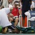 RETRANSMISSION FOR ALTERNATE CROP--Spain's David Ferrer has his right foot worked on during a medical timeout while playing Janko Tipsarevic of Serbia in the quarterfinals during the 2012 US Open tennis tournament,  Thursday, Sept. 6, 2012, in New York. (AP Photo/Peter Morgan)