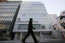 A man walks past a building where Mt. Gox is housed in Tokyo